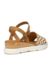 Sandal in pelle tan con dettagli bianchi intrecciati, suola tipo cork a zeppa, cinturino alla caviglia regolabile e suola bianca arrotondata.