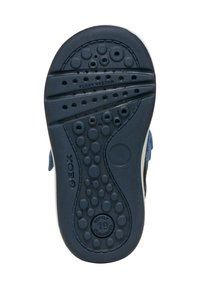 Suola in gomma blu con superficie testurizzata caratterizzata da accenti circolari e fori di ventilazione, etichettata "FLEXY SYSTEM" e "SPOTIFY 19."