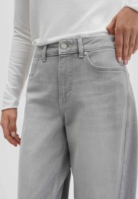 Gray, high-waisted jeans with a straight-leg cut, featuring front pockets, a button closure, and subtle stitching details.