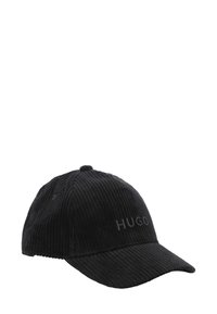 Casquette de baseball en velours côtelé noir avec une visière légèrement courbée et le logo brodé "HUGO" sur le devant. Tissu texturé avec des rayures verticales.