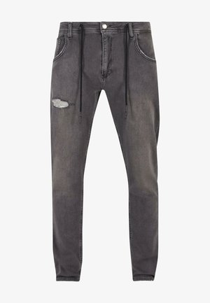 Slim-fit grijze denim jeans met een trekkoord in de taille, een versleten detail op de linkerknie, vijf zakken en contrasterende stiksels.