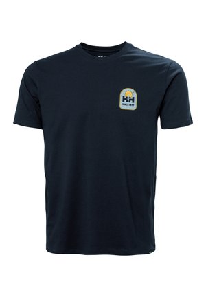 Navy blue cotton t-shirt with short sleeves, round neckline, and a small graphic patch featuring a logo and text "SINCE 1877" on the chest.