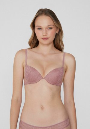 Kanten bralette in stofroze met verstelbare bandjes, gevoerde cups en een soepele textuur. Bloemenpatroon op de stof verhoogt de visuele detail.