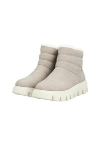 Bottines beiges avec doublure blanche moelleuse, tige en synthétique doux et semelle épaisse texturée avec des rainures profondes pour une bonne adhérence.
