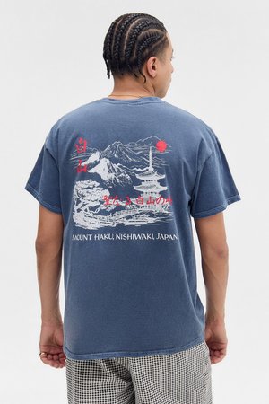 T-shirt en coton bleu marine avec un graphisme de montagnes, une pagode et un soleil rouge au dos, accompagné d'un texte japonais en dessous du design.