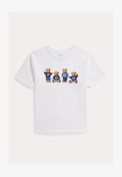Λευκό κοντομάνικο μπλουζάκι με τέσσερις αρκουδάκια που φορούν μπλε ρούχα, το καθένα με ένα γράμμα που σχηματίζει τη λέξη «POLO» στο στήθος.