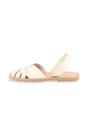 Flat sandal with white woven leather straps, tan insole, and beige rubber sole, featuring an open toe and back strap for secure fit.