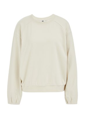 Hanorac crem cu decolteu rotund, mâneci raglan și tiv adunat. Confecționat dintr-un material moale, cu textură netedă și o ușoară elasticitate.