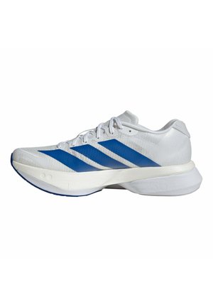 Zapatilla deportiva blanca con rayas azules, parte superior de malla, cordones y suela acolchada gruesa marcada con "36".