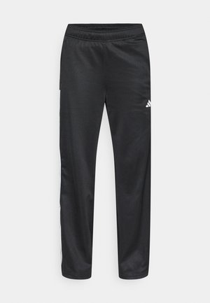 Calças desportivas pretas feitas de tecido macio com cintura elástica, apresentando riscas laterais brancas e um pequeno logótipo na parte inferior da perna esquerda.