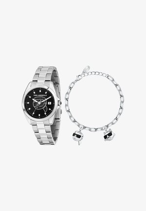 Silberne Karl Lagerfeld Uhr mit schwarzem Zifferblatt und Datumsfenster neben silbernem Kettenarmband mit Karl- und Katzenanhängern, die Sonnenbrillen tragen.