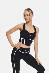 Black cropped sports top with white accents, featuring a square neckline and wide straps, paired with black leggings with white detailing.