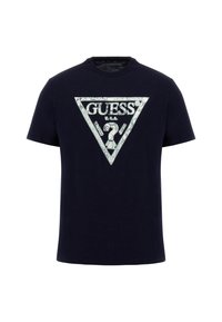 Navy blue cotton t-shirt featuring a triangular silver graphic with "GUESS?" and patterns. Crew neck and short sleeves, casual fit.