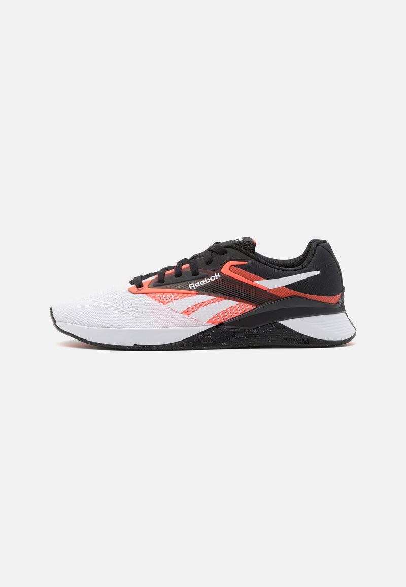 Zapatilla deportiva Reebok con una parte superior de malla blanca con acentos en negro y rojo brillante, un collar acolchado y una suela negra texturizada.