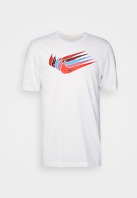 White cotton t-shirt featuring a multicolored Nike logo with red, blue, and black accents and a rounded neckline. Short sleeves, standard fit.