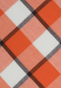 Orange, white, and brown plaid fabric with alternating solid and textured diagonal squares and intersecting dark and light lines.