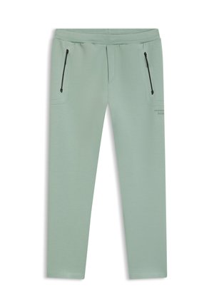 Lysendegrønne, tilspidsede bukser med sorte lynlåslommer på forsiden og elastisk linning.