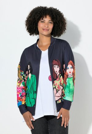 Navy bomber jacket featuring colorful graphic illustrations on sleeves, zip closure, and ribbed cuffs. Worn over a white T-shirt.