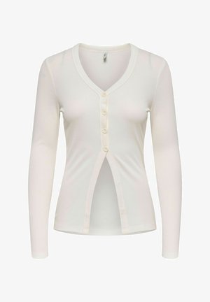 Cardigan blanc à côtes avec des manches longues, décolleté en V et fermeture à boutons sur le devant, présentant des boutons proéminents et un détail fendu à l'ourlet.