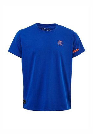 Blue short-sleeve T-shirt with orange "WATS" crossed letters logo on the chest and sleeve, and a small black label near the bottom hem.
