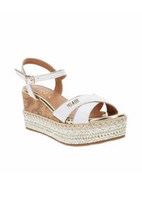Sandali wedge bianchi con plateau in sughero, dettagli in juta intrecciata e accenti dorati. Design open-toe con cinturino alla caviglia e fibbia regolabile.