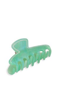 Grön hårklämma i transparent plast med subtila glittrande detaljer, med en dekorativ pärlliknande kant och åtta greppande tänder.