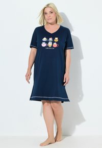 Nocna koszula w kolorze granatowym z bawełny, z dekoltem w kształcie V, krótkimi rękawami i kolorową grafiką "Latté and Chill" przedstawiającą rysunkowe kubki. Srebrny pasek na dole.