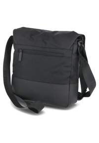 Black messenger bag with a fold-over flap, featuring a zippered back pocket, adjustable strap, and a smooth textured bottom panel.