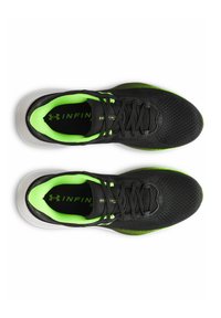 Black athletic shoes with a mesh upper, green accents, and a textured sole. Features a lace-up design and cushioned insole for comfort.