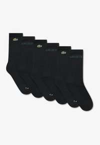Chaussettes en coton noir, design côtelé, avec inscription "LACOSTE" en vert et logo sur le bord-côte. Lot de six paires, longueur mi-mollet.