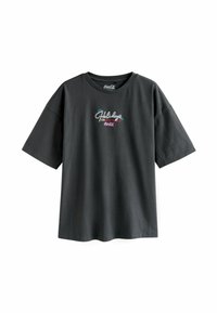 Svart bomulls t-shirt med korta ärmar, med flerfärgad broderad text som säger "Holidays 1993 ARE COMING Coca-Cola" på framsidan.