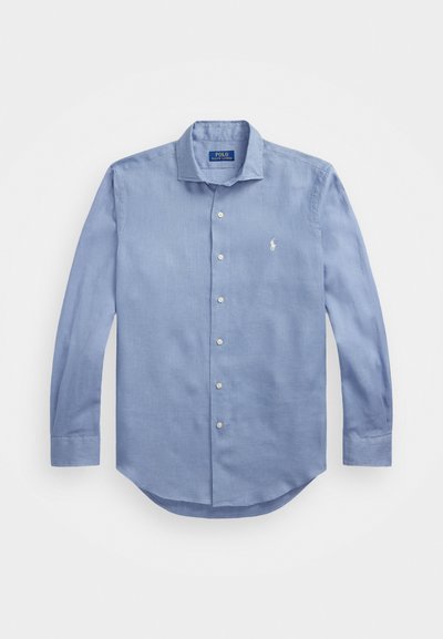 Svetlo modra srajca z dolgimi rokavi in gumbi, izdelana iz tkanine, z koničastim ovratnikom, sedmimi gumbi in majhnim logom na prsih.