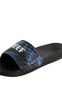 Black slide sandal with a textured footbed. The strap features a blue abstract pattern and white "REEF" logo. Flat sole design.