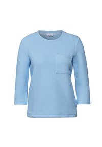 Lichtblauwe lange mouwen sweatshirt gemaakt van gestructureerde wafelstof, met een ronde halslijn en een vierkante borstzak.