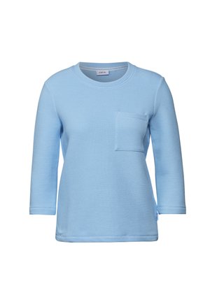 Ljusblå långärmad sweatshirt i teksturerad våffelväv, med rund halsringning och en fyrkantig bröstficka.