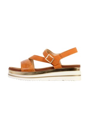 Brown leather platform sandal with adjustable buckle strap and white ridged sole with gold accent stripe.