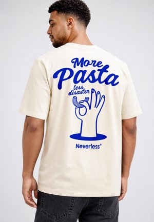 Man wearing cream t-shirt with blue text "More Pasta less disaster" and hand holding pasta graphic on the back.