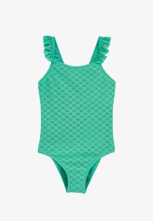 Zaļš peldkostīms ar volānu lencēm, uz tā ir teksturēts raksts ar maziem izgriezuma elementiem. Izgatavots no gluda, viegla materiāla.