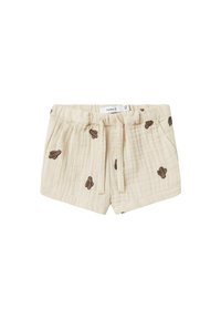 Shorts en coton beige avec une finition texturée, ornés d'une broderie de cactus marron, dotés d'une taille élastique et d'un cordon de serrage pour l'ajustement.