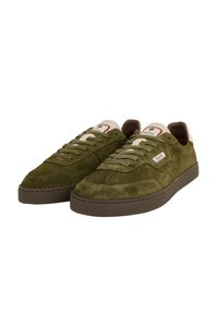 Zapatillas de ante verde con un acabado texturizado, puntera redonda, suela plana de goma y acentos en crema en la lengüeta y el talón. Presentan un diseño de cordones.