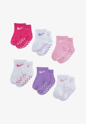 Sešu pāru potīšu zeķu komplekts rozā, violetā un baltā krāsā, ar kontrastējošiem Nike logotipiem un neslīdošām punktiņām uz zoles.