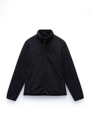 Chaqueta de forro polar negra con cierre de cremallera, cuello alto y bolsillos laterales. Tejido texturizado con acentos de ribete liso en los laterales y el cuello.