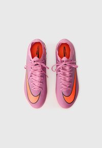 Pink Nike Mercurial soccer cleats with orange accents, smooth texture, laces at the front, and a curved shape for streamlined design.