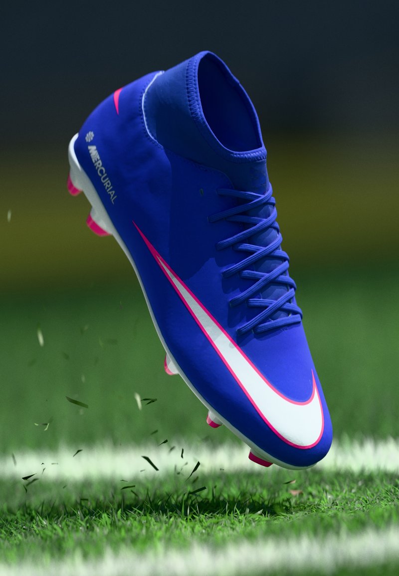 Taco de fútbol Nike Mercurial, azul con acentos en blanco y rosa, presenta un diseño elegante, parte superior texturizada y tacos moldeados en rosa para tracción.