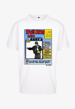 White cotton t-shirt featuring a colorful graphic print of a magazine cover, displaying text and an image of a person pointing.
