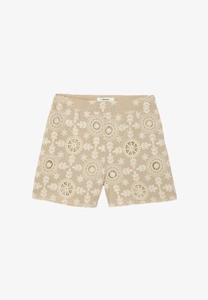 Short beige avec broderie florale blanche et détails découpés, avec une ceinture et une étiquette à l'arrière.