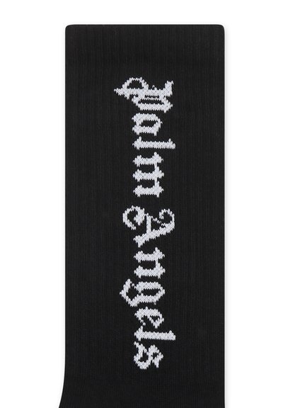 Calze di maglia nere con testo ornamentale bianco che recita "Palm Angels", caratterizzate da una texture a coste e una finitura liscia.