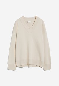 Maglione beige a collo a V realizzato in tessuto testurizzato. Presenta spalle scese e una vestibilità rilassata con polsini e orlo a coste.