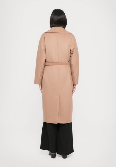 Long, beige wool coat with a belt, large collar, and long sleeves. View from the back, showing a straight silhouette and minimal detail.