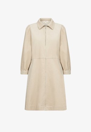 Bežist õhukeses nöörkanga kleit, millel on krae ja ees tõmblukk ning 3/4 pikkuses puhvvarrukad. Omab mugavat lõiget ja peeneid püstiseid jooni.